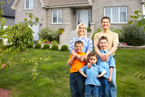 family in front of house